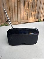 Front view showing speaker grille, HD Radio logo and antenna