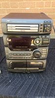 Front view showing entire JVC stereo unit with CD changer, cassette deck and controls