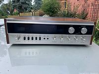 Front three-quarter view of Sherwood S-7300 receiver showing wood cabinet and full control layout