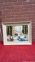 Front view of framed winter landscape painting