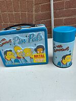 Front view of lunchbox and thermos showing primary graphics