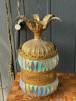 Full view of hanging fixture showing filigree, prisms, chain