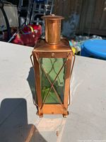Front view of copper lantern showing green glass panel and cross brace