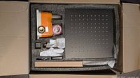 Boxed shower kit with square shower head, valve body, fittings, hardware and Teflon tape in foam packaging