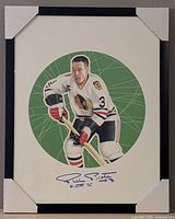 Front view of framed, autographed Pierre Pilote photo