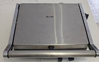 Closed Breville stainless steel panini press