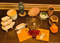 overview of all items including solar pump boxes, feeders, pig figurines, owl candle and holder, pots, dishware