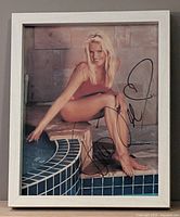 Front view of framed, autographed Gena Lee Nolin photo showing entire image, frame, and signature.