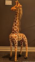 Full view of upright plush giraffe
