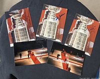 All five autographed photographs arranged together showing signatures and imagery