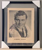 Framed portrait showing autograph, frame, caption, protective corners