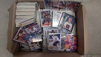 Open storage box showing stacks of hockey cards, many sleeved and top loaded
