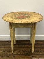 Full view of oval painted table front perspective