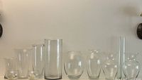Full lineup of assorted clear glass vases on shelf