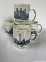 Front view of all four Starbucks city mugs