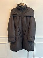 Front view hanging, showing full coat, draped collar and pockets