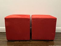 Front view of two red cube ottomans side by side