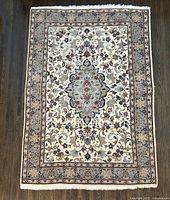 Full view of rug showing complete pattern and fringe