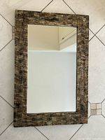 Front view of mirror hanging, showing full frame and glass