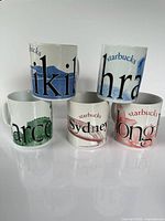 Front view of all five Starbucks City Mugs showing city names