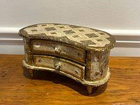 Front angled view showing gilt finish, kidney shape, two drawers