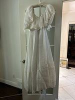 Full view of wedding dress hanging, showing overall style and length