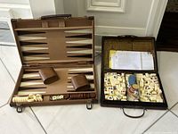 Both game cases open showing contents