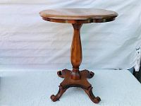 Full view of round scalloped maple table on central pedestal
