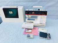 Complete lot showing sewing machine, carrying case, foot pedal, manual, accessories box, and attachment.