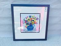 Framed watercolor painting showing full view with bouquet of multicolored pansies in blue vase.