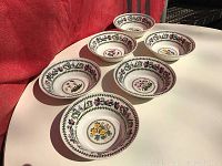 Set of six vintage Portmeirion bowls showing various floral patterns with decorative borders on a white background.