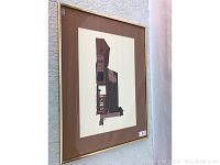 Framed abstract architectural print mounted on wall showing the overall style, matting, and framing.