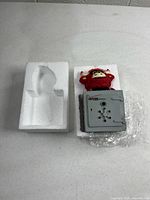 Coin bank in styrofoam packaging showing molded insert