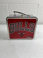 Front view showing Bulls logo, red panel, clasp and handle