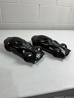 Two identical Darth Vader Hot Wheels cars, top view
