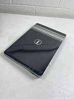 Closed Dell Inspiron 1525 showing black lid and logo