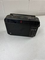 Front view showing tuning dial, speaker grille, control knobs