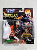 Front of sealed Starting Lineup Heisman Collection package showing figure, helmet, trophy