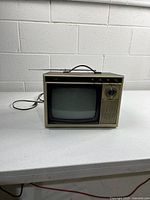 Front view showing screen, controls, antenna