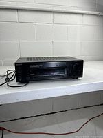 Front angled view of Sony STR-D615 receiver with cords visible
