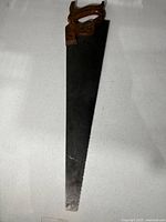 Full view of the Disston hand saw showing entire blade and handle