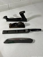 Four woodworking tools laid out on table