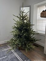 Undecorated artificial Christmas tree on metal stand
