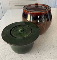 Both ceramic fire pots showing size and color comparison