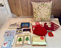 group shot of pillow, towels, brooch pouch and multiple card packs