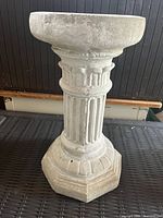 Side view showing fluted column, octagonal base, and round top