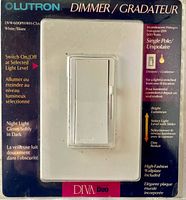 Front view of packaged Lutron Diva DVW-600PH-WH-CSA dimmer switch showing specifications and condition