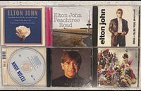All six Elton John CDs laid out showing front cover art and one disc label