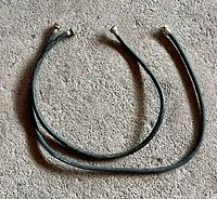 two short black connector hoses laid flat showing length and connectors