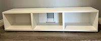 Front view showing three open compartments and legs